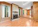 Bright living room featuring wood paneled walls, a brick fireplace, and a skylight for natural lighting at 407 W Sixth St, Siler City, NC 27344
