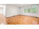 Bright living room featuring light-colored walls, hardwood floors and a door with a window at 407 W Sixth St, Siler City, NC 27344
