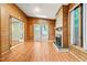Bright living room featuring wood paneled walls, a brick fireplace, and multiple skylights for natural lighting at 407 W Sixth St, Siler City, NC 27344