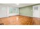 Spacious living room featuring beautiful hardwood floors, two entry doors and a large window at 407 W Sixth St, Siler City, NC 27344