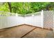 Secluded outdoor patio surrounded by a white lattice fence, offering privacy and a peaceful retreat at 407 W Sixth St, Siler City, NC 27344