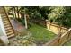 Private backyard features a small lawn, stone pathway, and wooden fence at 436 Edgepine Dr, Holly Springs, NC 27540