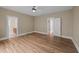 Large bedroom with wood floors, ceiling fan, and ensuite bathroom access at 436 Edgepine Dr, Holly Springs, NC 27540