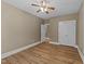 Well-lit bedroom features a ceiling fan, closet space, and new flooring at 436 Edgepine Dr, Holly Springs, NC 27540