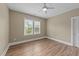 Bedroom with wood-look flooring, ceiling fan and double-hung windows at 436 Edgepine Dr, Holly Springs, NC 27540