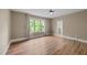Bedroom with hardwood floors, soft drapery, and ensuite bathroom access at 436 Edgepine Dr, Holly Springs, NC 27540