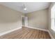 Bright bedroom featuring wood floors, ceiling fan, and fresh paint at 436 Edgepine Dr, Holly Springs, NC 27540