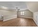 Spacious bonus room with modern flooring, ceiling fan, and a large window for ample natural light at 436 Edgepine Dr, Holly Springs, NC 27540