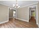 Elegant dining area features hardwood floors, a chandelier, and seamless access to other living spaces at 436 Edgepine Dr, Holly Springs, NC 27540