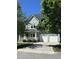 Charming two-story home with a three-car garage, inviting front porch, and manicured landscaping at 436 Edgepine Dr, Holly Springs, NC 27540