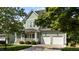 Charming two-story home featuring a welcoming front porch and a two-car garage at 436 Edgepine Dr, Holly Springs, NC 27540