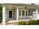 Inviting front porch with a swing, a ceiling fan, and well-manicured landscaping at 436 Edgepine Dr, Holly Springs, NC 27540