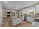 Bright and spacious kitchen with stainless appliances, granite countertops, island and access to outdoor deck at 436 Edgepine Dr, Holly Springs, NC 27540