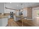 Bright kitchen features stainless steel appliances, granite countertops, and a center island at 436 Edgepine Dr, Holly Springs, NC 27540