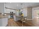 Modern kitchen featuring stainless steel appliances, a center island with seating, and ample cabinet space at 436 Edgepine Dr, Holly Springs, NC 27540