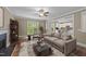 Comfortable living room with a fireplace, a modern sofa, and an open view into the bright kitchen at 436 Edgepine Dr, Holly Springs, NC 27540