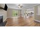 Spacious living room with hardwood floors, fireplace, and large window offering plenty of natural light at 436 Edgepine Dr, Holly Springs, NC 27540