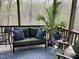 Cozy screened-in porch featuring comfortable seating and decorative plants, perfect for relaxation at 436 Edgepine Dr, Holly Springs, NC 27540