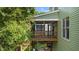 Elevated screened-in porch with stairs and a view of the lush backyard at 436 Edgepine Dr, Holly Springs, NC 27540