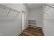 Walk-in closet featuring shelving and wood floors to provide optimal organization at 436 Edgepine Dr, Holly Springs, NC 27540