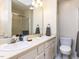 Bright bathroom featuring a double sink vanity and shower with glass enclosure at 4646 Fawnbrook Cir, Raleigh, NC 27612