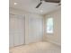 Bedroom with ample closet space, neutral carpet, and a bright window, ideal for storage and comfort at 4646 Fawnbrook Cir, Raleigh, NC 27612