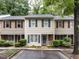 Charming townhome featuring neutral siding, brick accents, and neatly trimmed bushes at 4646 Fawnbrook Cir, Raleigh, NC 27612