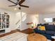 Cozy living room features a ceiling fan, staircase, and a decorative rug with a comfortable seating arrangement at 4646 Fawnbrook Cir, Raleigh, NC 27612