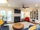 Bright living room with a fireplace, ceiling fan, and a stylish rug at 4646 Fawnbrook Cir, Raleigh, NC 27612