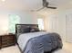 Comfortable main bedroom with a ceiling fan, plush bedding, and large closets, ideal for relaxation at 4646 Fawnbrook Cir, Raleigh, NC 27612
