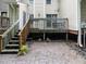The patio features a cobblestone path and wooden stairs up to a deck at 4646 Fawnbrook Cir, Raleigh, NC 27612