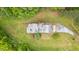 Birds-eye view of home showing roof design and tree lined landscaping with expansive green grass at 4874 Thom Rd, Mebane, NC 27302