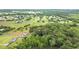 Overhead photo shows property with water feature surrounded by lush trees at 4874 Thom Rd, Mebane, NC 27302