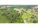 Aerial photo showcasing property lines with pond and forested surroundings at 4874 Thom Rd, Mebane, NC 27302