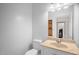 Powder room with large mirror and stone countertop at 4874 Thom Rd, Mebane, NC 27302