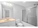 Bathroom featuring a shower with sliding glass doors, a sink with vanity, and a toilet at 4874 Thom Rd, Mebane, NC 27302