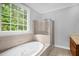 Bathroom with a jetted tub, glass-enclosed shower, and a large window at 4874 Thom Rd, Mebane, NC 27302