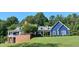 Beautiful two-story home with manicured lawn, covered porch, and brick retaining wall at 4874 Thom Rd, Mebane, NC 27302