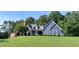 Charming blue two-story home with a well-manicured lawn and inviting front porch at 4874 Thom Rd, Mebane, NC 27302
