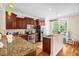 Spacious kitchen featuring granite countertops, stainless steel appliances, and a breakfast bar at 4874 Thom Rd, Mebane, NC 27302