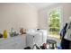 Bright laundry room with machines and counterspace at 4874 Thom Rd, Mebane, NC 27302