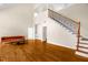 Bright living room featuring hardwood floors, a staircase, and high ceilings at 4874 Thom Rd, Mebane, NC 27302