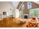 Spacious living room with fireplace, hardwood floors, and large windows at 4874 Thom Rd, Mebane, NC 27302