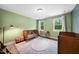Charming Bedroom with two wooden cribs, natural light and neutral color palette at 5020 Mimosa Dr, Durham, NC 27713