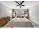 Bedroom with a comfortable bed, soft lighting, dresser, and natural light from the windows at 5020 Mimosa Dr, Durham, NC 27713