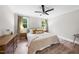 Bedroom featuring a large bed with bedside tables, soft lighting, and a dresser at 5020 Mimosa Dr, Durham, NC 27713