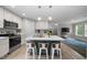 Modern kitchen features stainless steel appliances, a large island, and an open concept to the living area at 5020 Mimosa Dr, Durham, NC 27713