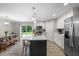 Bright kitchen features a spacious island, stainless steel appliances, and a view to the dining area at 5020 Mimosa Dr, Durham, NC 27713