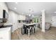 Open-concept kitchen has an eat-in island, stainless appliances, and flows into the living area at 5020 Mimosa Dr, Durham, NC 27713