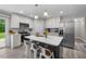 Modern kitchen with stainless steel appliances, a large island, and white cabinets, perfect for cooking and gathering at 5020 Mimosa Dr, Durham, NC 27713